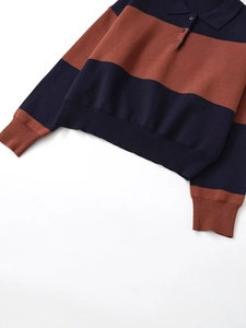 Detail of the navy and caramel striped knit polo shirt featuring a ribbed collar and buttons