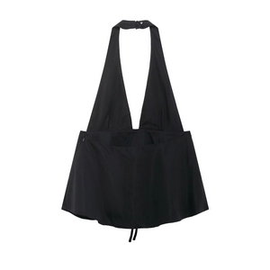 Detail of sexy black V-neck halter top with bow accent and flattering flared hemline