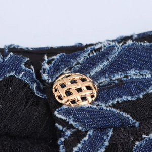 Elegant retro vintage trousers featuring black lace patchwork with gold woven button detail