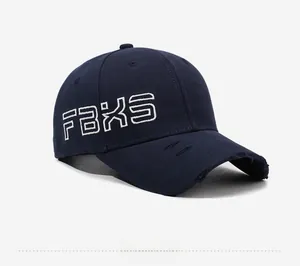 Detail of navy blue baseball cap featuring FBXS embroidery and distressed brim edge