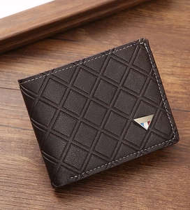 Detailed view of dark brown leather wallet with diamond pattern and white stitching