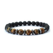 Detail of natural tiger eye and matte black beads with hematite spacers on a stretch bracelet