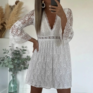 Detailed view of white floral lace texture and hollow flared sleeves on a V-neck mini dress