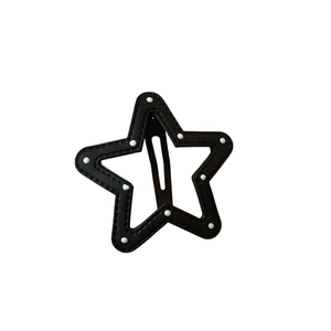 Star-shaped hair clip in black and white polka dot pattern with white stitching
