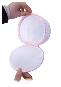 Detail of round mesh laundry bag showing internal plastic frames for bra protection