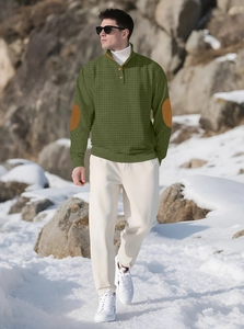 Detail of waffle-knit fabric texture with vintage elbow patches on a men's sweatshirt