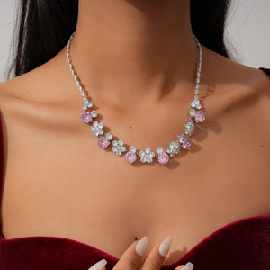 Close-up of pink and white zircon flower pendant necklace with shimmering diamond-set chain