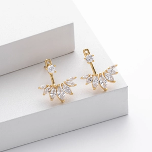 Detailed macro view of S925 sterling silver gold earrings with marquise-cut crystals