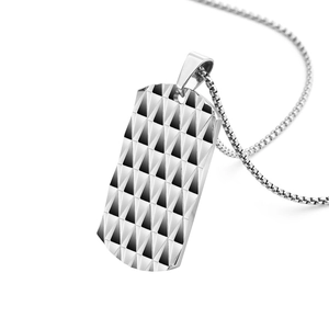 Macro shot of silver titanium steel pendant with diamond-shaped geometric texture and box chain
