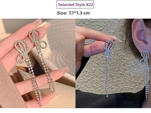 Detailed view of silver bow drop earrings with tassels, measuring 7.7 by 1.3 cm