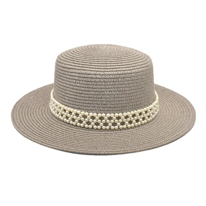 Detail of dark straw flat top hat featuring an elegant faux pearl mesh band decoration