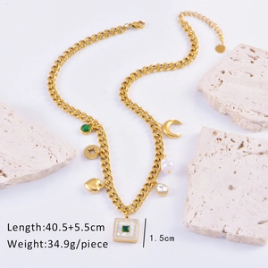 Detail of bohemian gold chunky necklace with green square charm and multi-element pendants