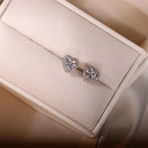 Elegant heart-shaped zircon silver stud earrings in a white leather jewelry box