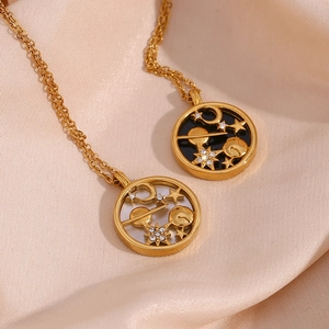Detailed shot of celestial gold necklaces with star and moon charms on beige silk