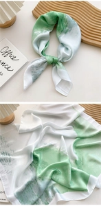 Detail of green and white abstract ink pattern on a premium satin silk square scarf