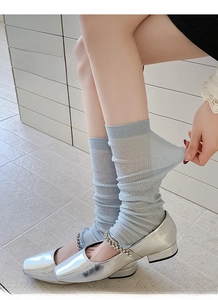Close-up of high elasticity light blue mesh socks stretched on leg with Mary Jane shoes