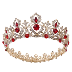 Detailed macro view of vintage gold bridal crown with red rhinestones and crystals