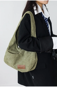 Olive green corduroy tote bag showing large capacity and textured stripe detail