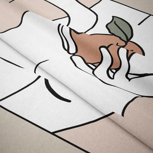 Detail of heavy fabric texture and minimalist line art print on a boho wall tapestry