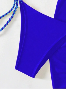 Close-up of royal blue bikini fabric with double-needle stitching and braided straps