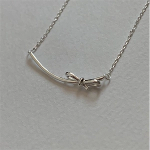 Minimalist 925 sterling silver bow pendant necklace on a clean white background