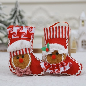 Set of two red and white fabric Christmas stockings featuring gingerbread man and lady