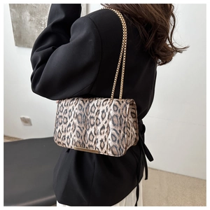 Detail view of leopard print shoulder bag with gold chain and plush fabric texture