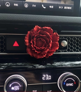 Deep red peony car air vent clip diffuser installed on a modern vehicle dashboard