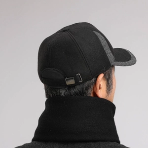 Detail of tweed stitching and adjustable metal buckle on men's winter baseball cap