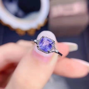 Macro shot of square lavender gemstone ring with intricate silver filigree details