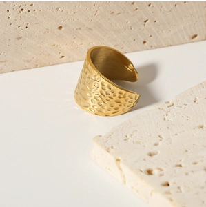 Macro detail of golden hammered texture and adjustable open band on wide vintage ring