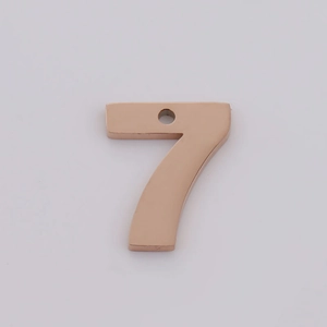 Detailed close-up of rose gold number 7 stainless steel pendant with mirror finish