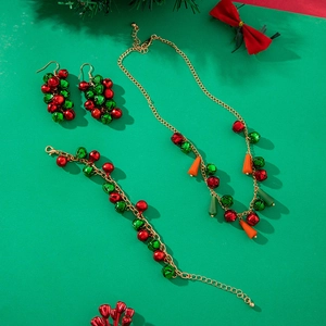 Macro shot of festive red and green bell jewelry set including necklace and earrings