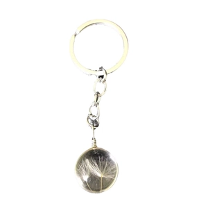 Handmade dandelion seed glass ball keychain with silver metal ring on white background