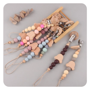 Detail of beech wood pacifier clip with silicone beads and cute bear animal shapes