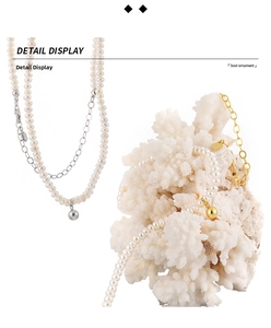 Detail of S925 sterling silver chain with freshwater pearls and metallic ball pendant