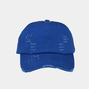 Close-up of bright blue washed cotton baseball cap featuring distressed ripped details