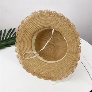 Detail of straw hat interior showing woven texture and adjustable elastic chin strap