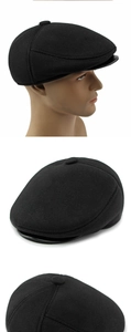 Detail of black wool flat cap featuring a premium leather brim and stitched panel crown