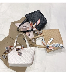 Detailed flat lay of quilted PU tote bags with silk scarves in black, white, and khaki