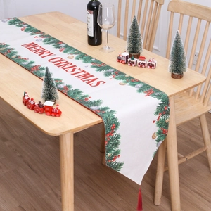 Christmas table runner with Merry Christmas print, red tassels and festive pine pattern