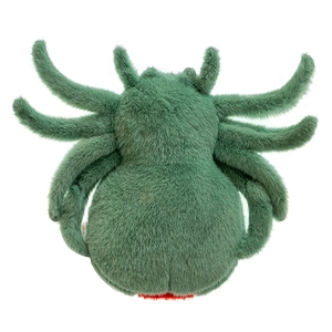 Close-up of the soft green plush fabric texture and quality stitching on the spider toy