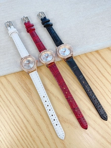 Detailed view of quartz watches with diamond bezels and crocodile-pattern leather straps