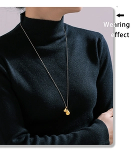 Wearing effect of golden waterdrop pendant necklace on black turtleneck sweater
