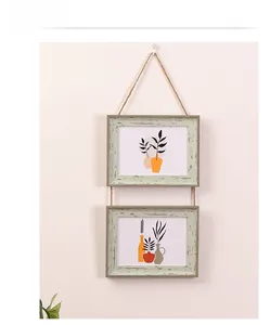 Close-up of dual horizontal rustic wood frames with jute rope and botanical prints