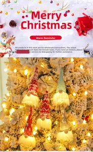 Detail of light-up Christmas gnome ornaments with reindeer patterns on a festive tree