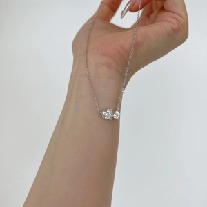 Close-up of S925 sterling silver necklace featuring two heart-shaped pear zirconia pendants