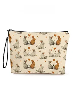 Detailed pattern display of bunny cosmetic bag featuring black zipper and wrist strap