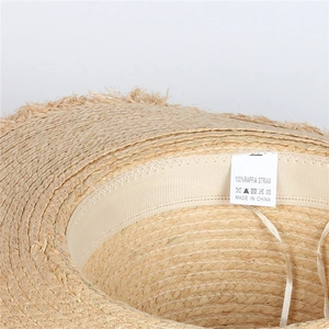 Detail of adjustable inner sweatband and 100% raffia straw weave on a sun hat