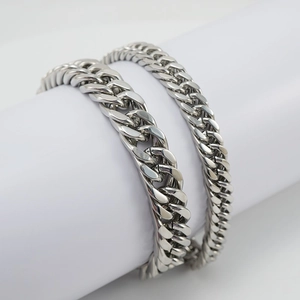 Men's silver stainless steel Cuban link bracelet in punk hip-hop style on white display